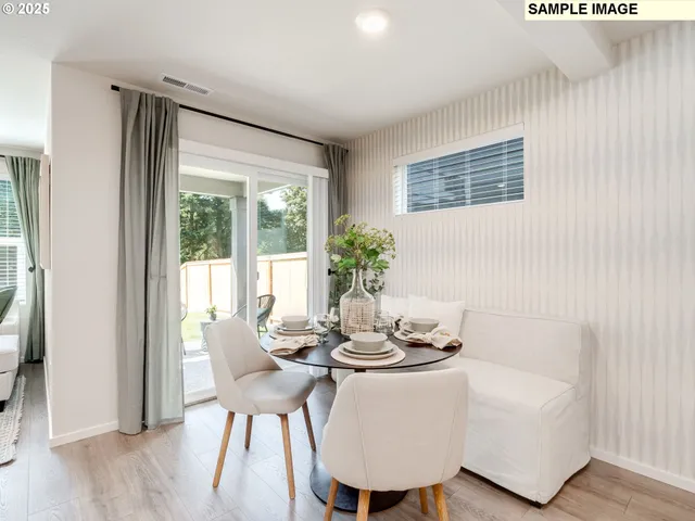 a dining room with furniture and wooden floor