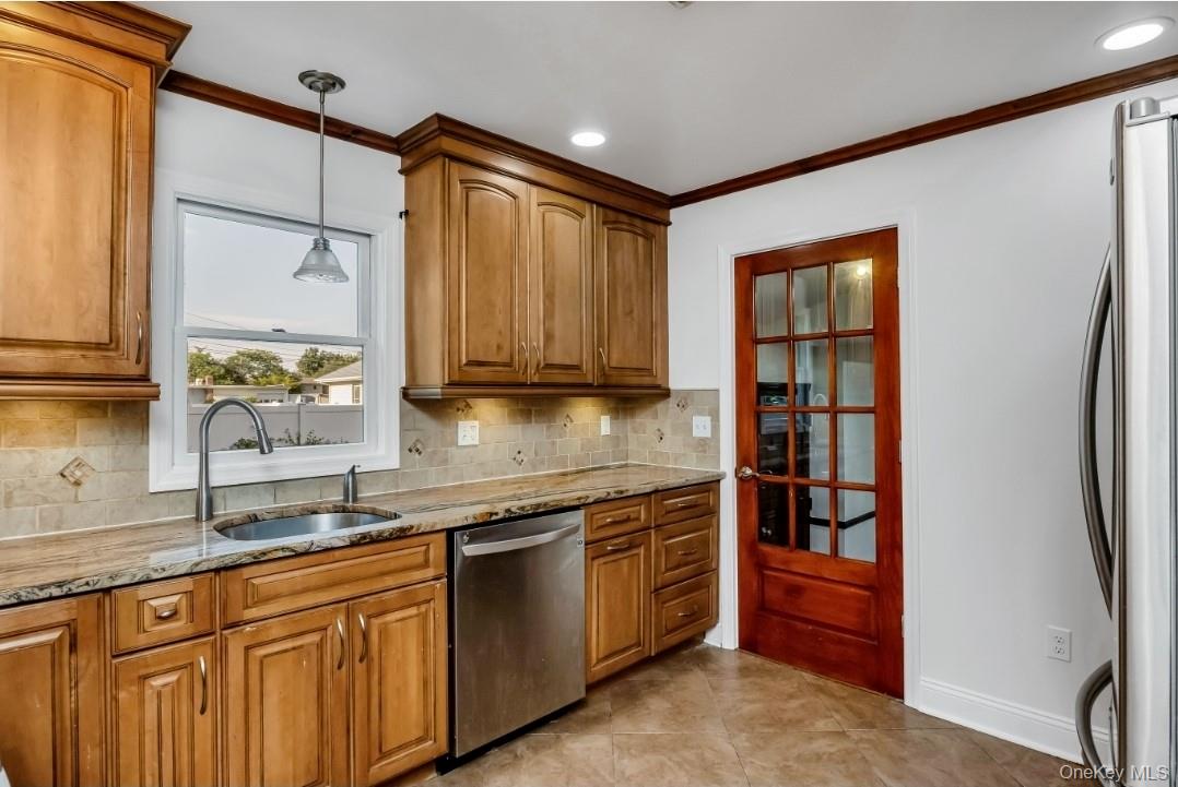 31 Fuller Avenue West Babylon, NY 11704 - Photo 14 of 33 a kitchen with stainless steel appliances granite countertop a refrigerator and a sink
