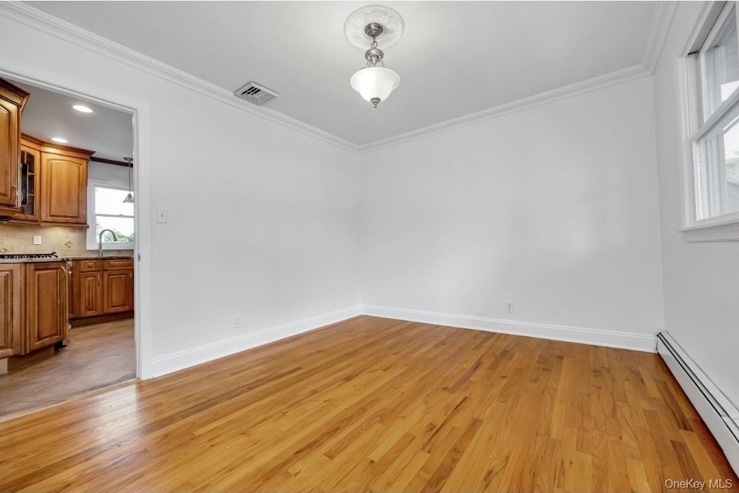 31 Fuller Avenue West Babylon, NY 11704 - Photo 15 of 33 a view of empty room with wooden floor and fan