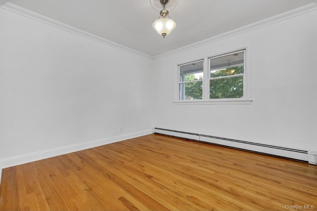 31 Fuller Avenue West Babylon, NY 11704 - Photo 16 of 33 a view of an empty room with wooden floor and a window