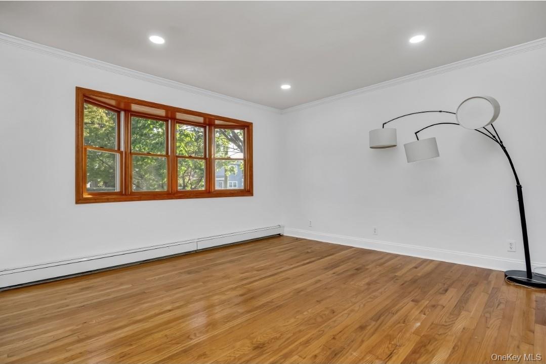 31 Fuller Avenue West Babylon, NY 11704 - Photo 19 of 33 a view of an empty room with wooden floor and a window