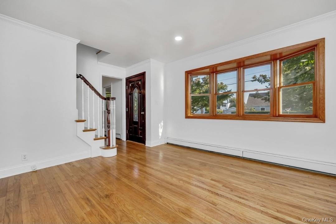 31 Fuller Avenue West Babylon, NY 11704 - Photo 20 of 33 a view of an empty room with wooden floor and a window