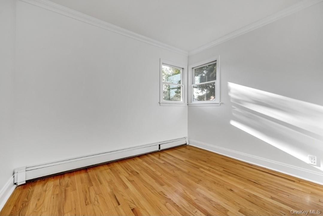 31 Fuller Avenue West Babylon, NY 11704 - Photo 21 of 33 a view of empty room with wooden floor and fan