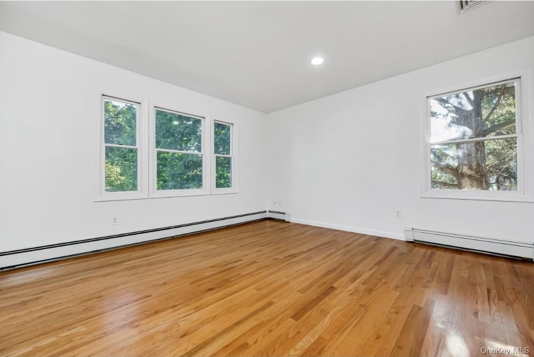 31 Fuller Avenue West Babylon, NY 11704 - Photo 25 of 33 a view of an empty room with wooden floor and a window