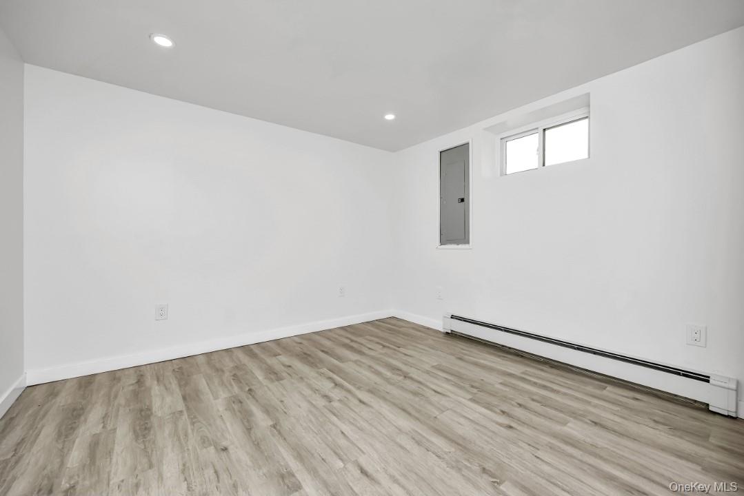31 Fuller Avenue West Babylon, NY 11704 - Photo 27 of 33 an empty room with wooden floor and windows