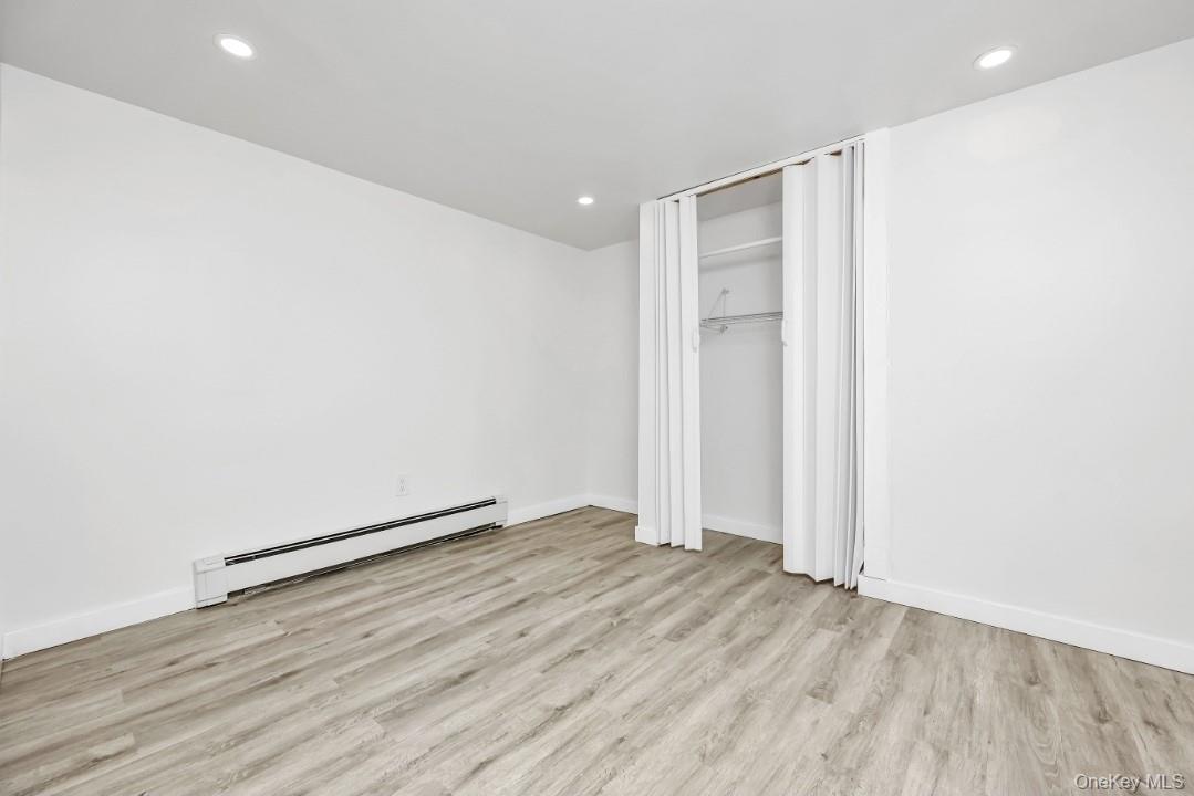 31 Fuller Avenue West Babylon, NY 11704 - Photo 28 of 33 an empty room with wooden floor