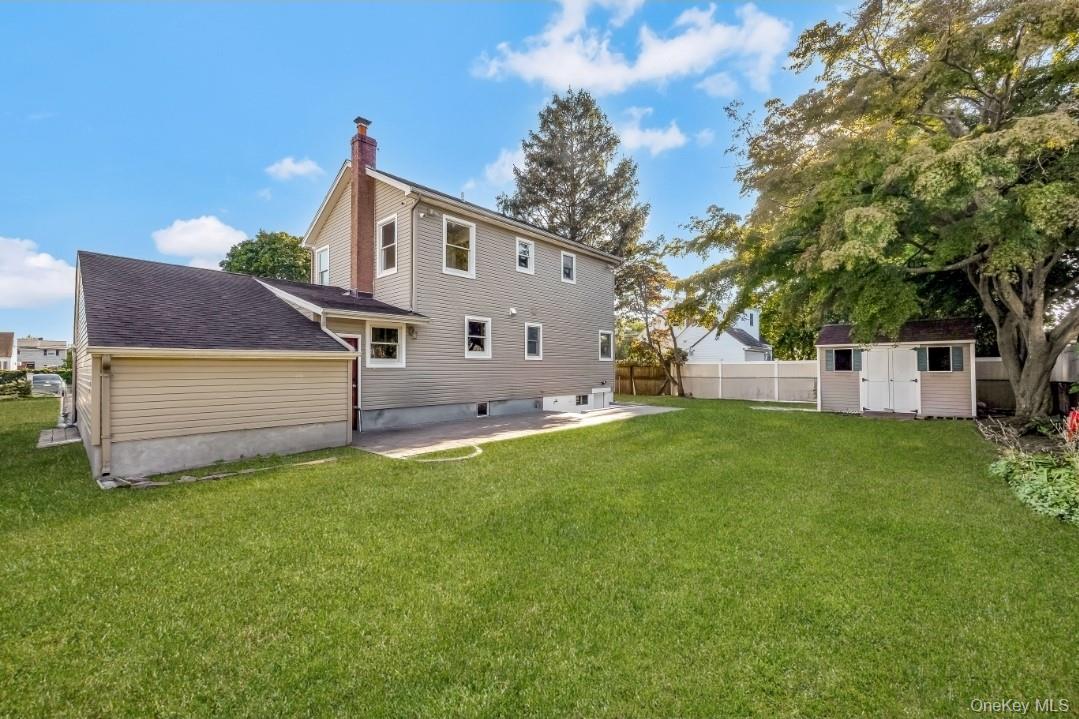 31 Fuller Avenue West Babylon, NY 11704 - Photo 8 of 33 a front view of a house with a yard and trees