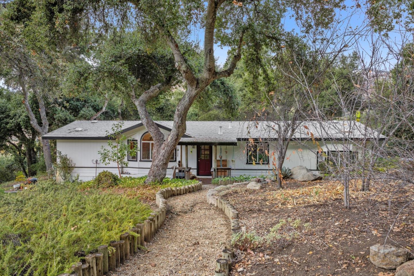 18190 Cachagua Road Carmel Valley, CA 93924 - Photo 14 of 35 a front view of a house with a garden