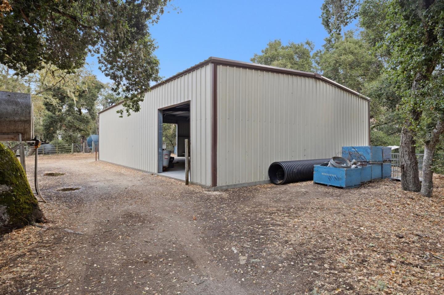 18190 Cachagua Road Carmel Valley, CA 93924 - Photo 27 of 35 a view of a backyard with potted plants and large tree