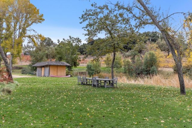a backyard of a house with table and chairs