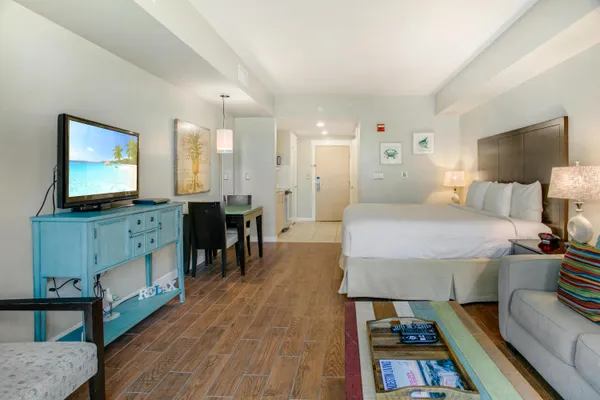 a bedroom with furniture and a flat screen tv