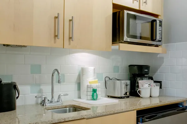 a kitchen with a sink and a stove top oven
