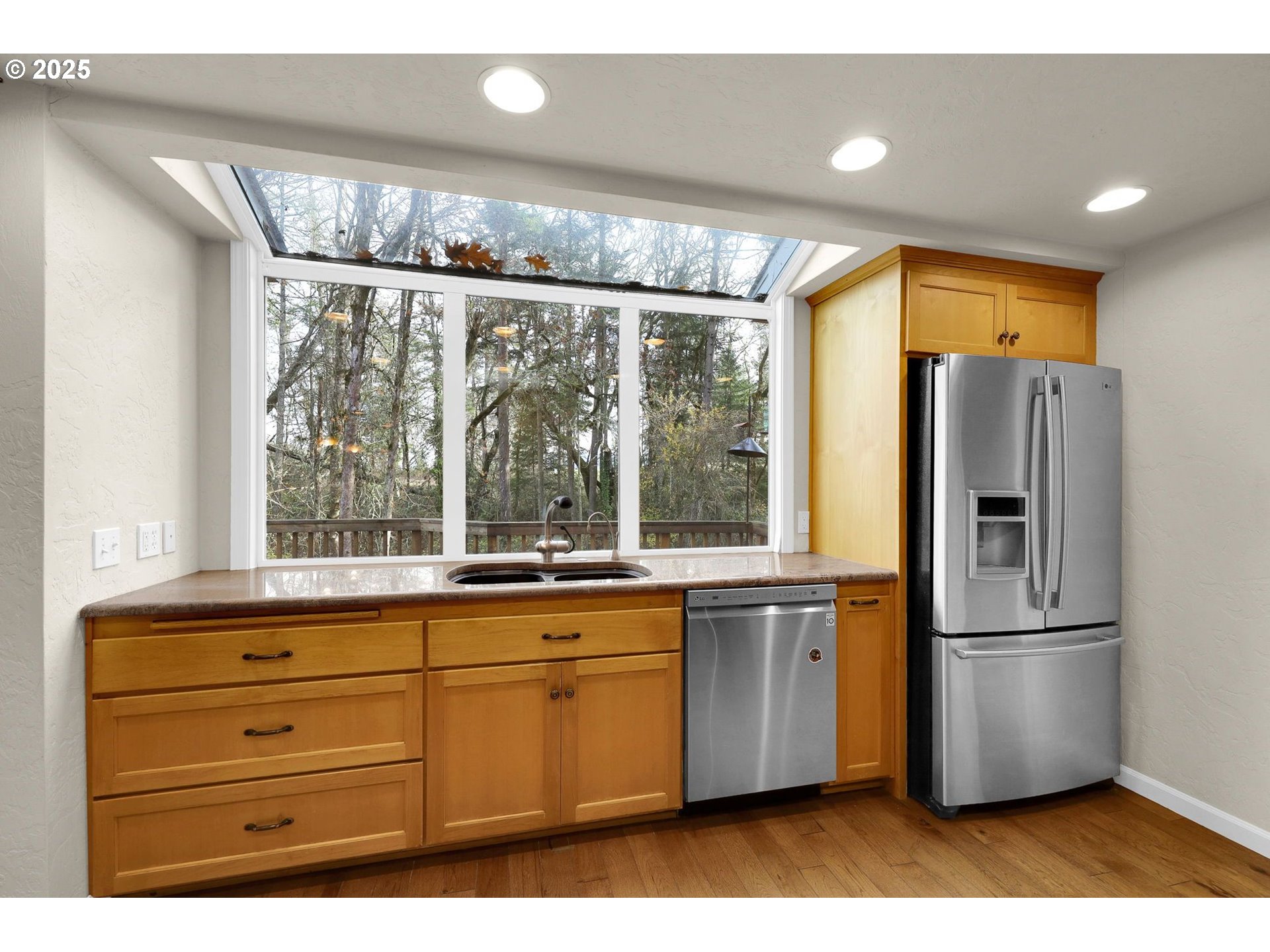 4103 Brae Burn Drive Eugene, OR 97405 - Photo 12 of 22 a kitchen with a refrigerator a sink and cabinets
