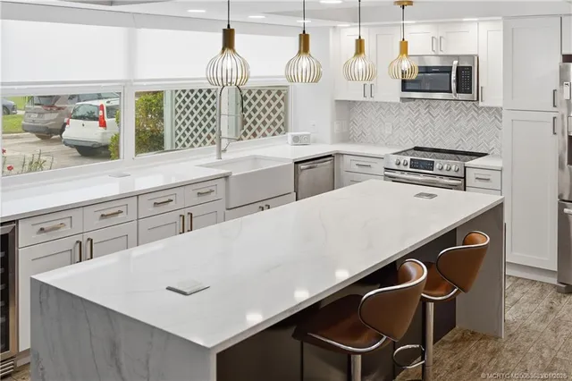 a kitchen with stainless steel appliances a sink and a stove