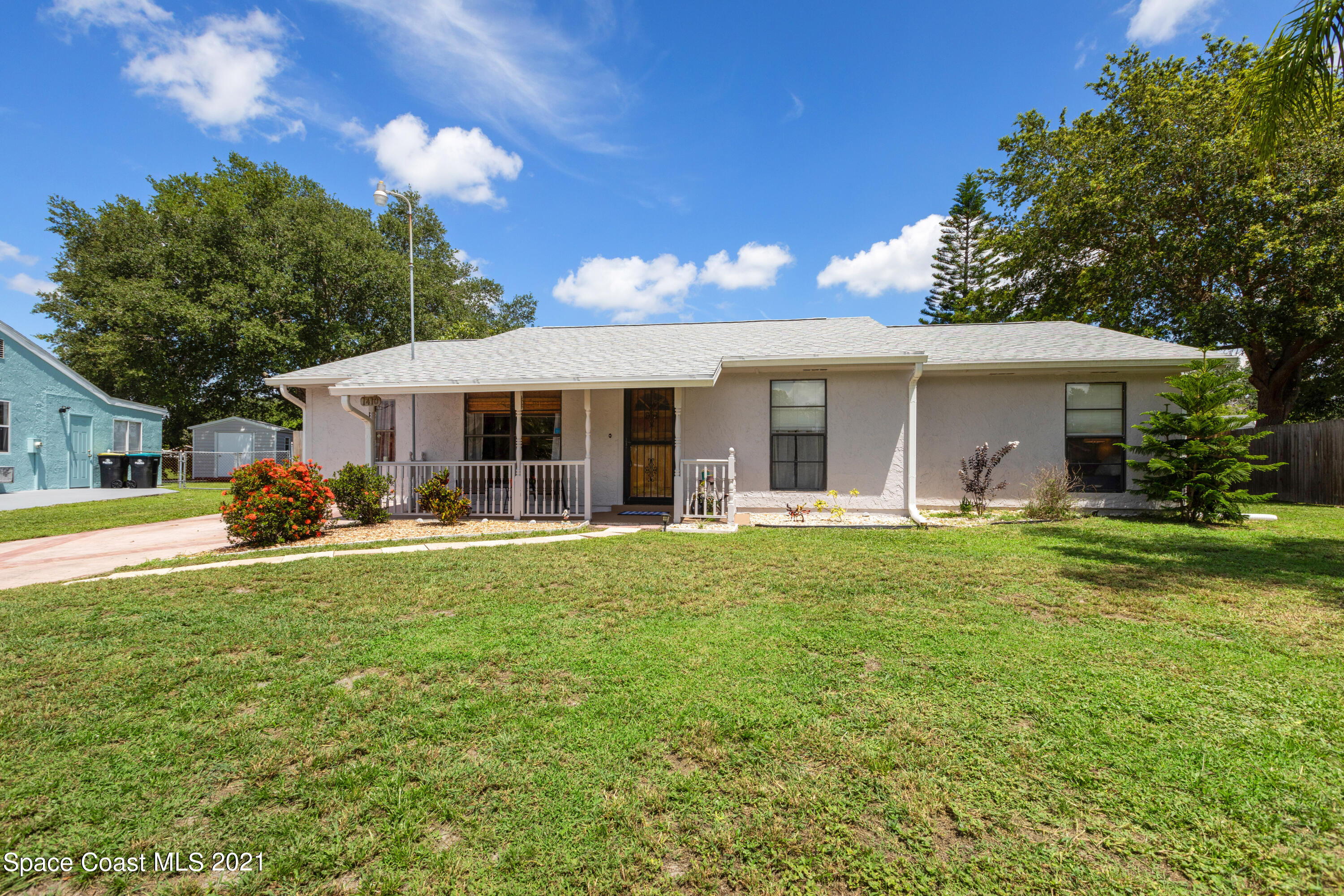 1410 Creel Road Northeast Palm Bay, FL 32905 - Photo 1 of 39 a view of a house with a backyard patio and swimming pool