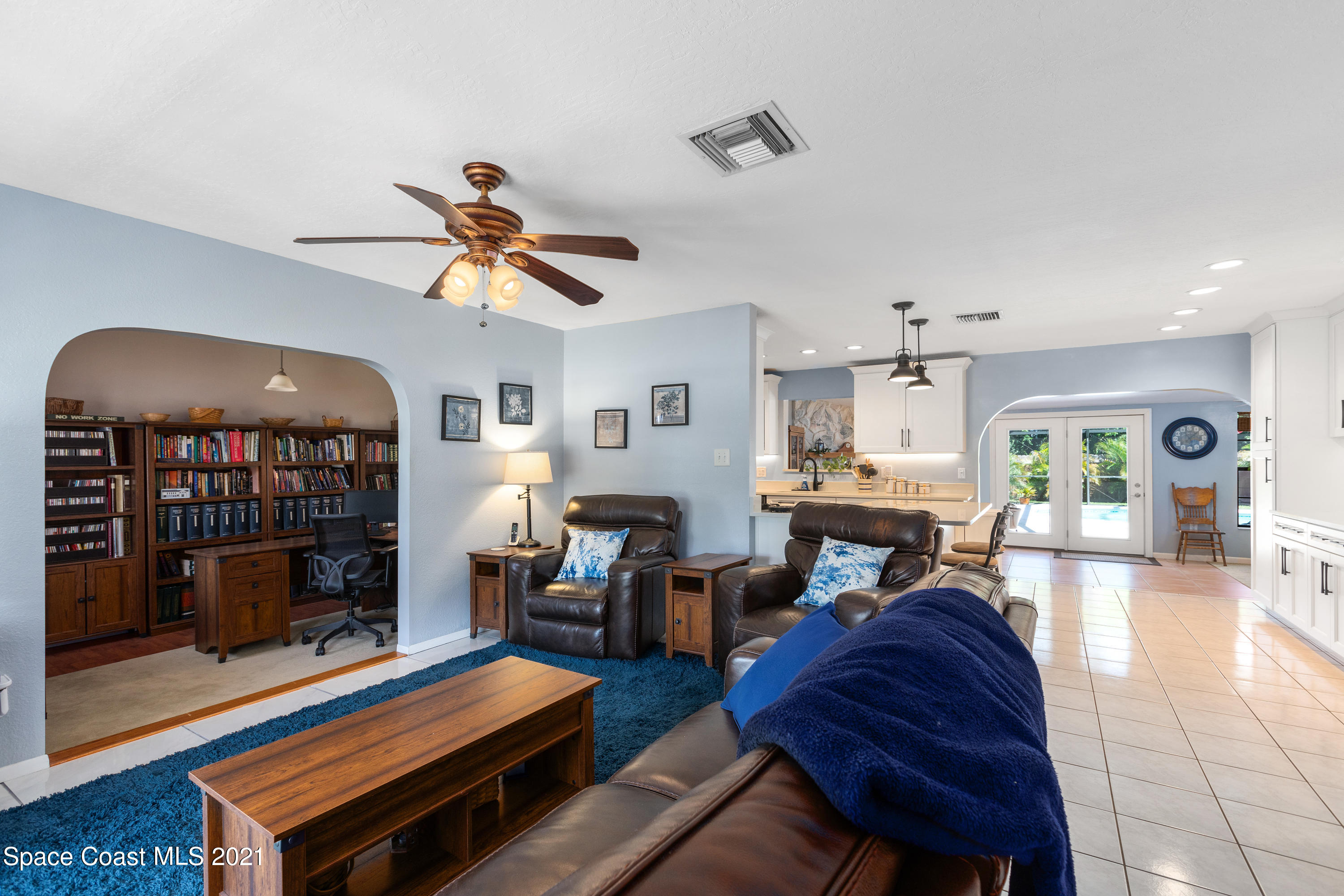 1410 Creel Road Northeast Palm Bay, FL 32905 - Photo 11 of 39 a living room with furniture a fireplace and a dining table