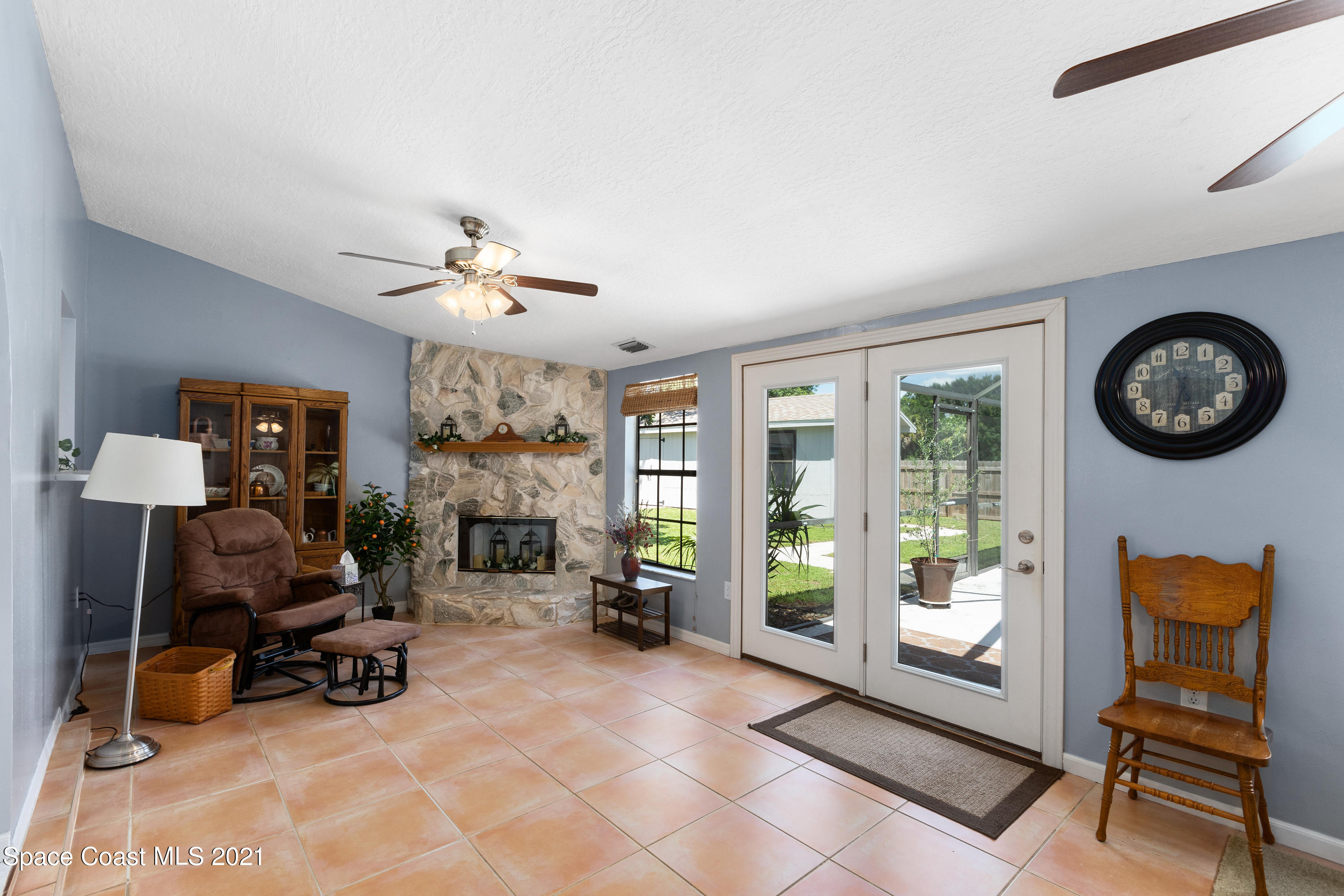 1410 Creel Road Northeast Palm Bay, FL 32905 - Photo 14 of 39 a living room with furniture a clock and a large window