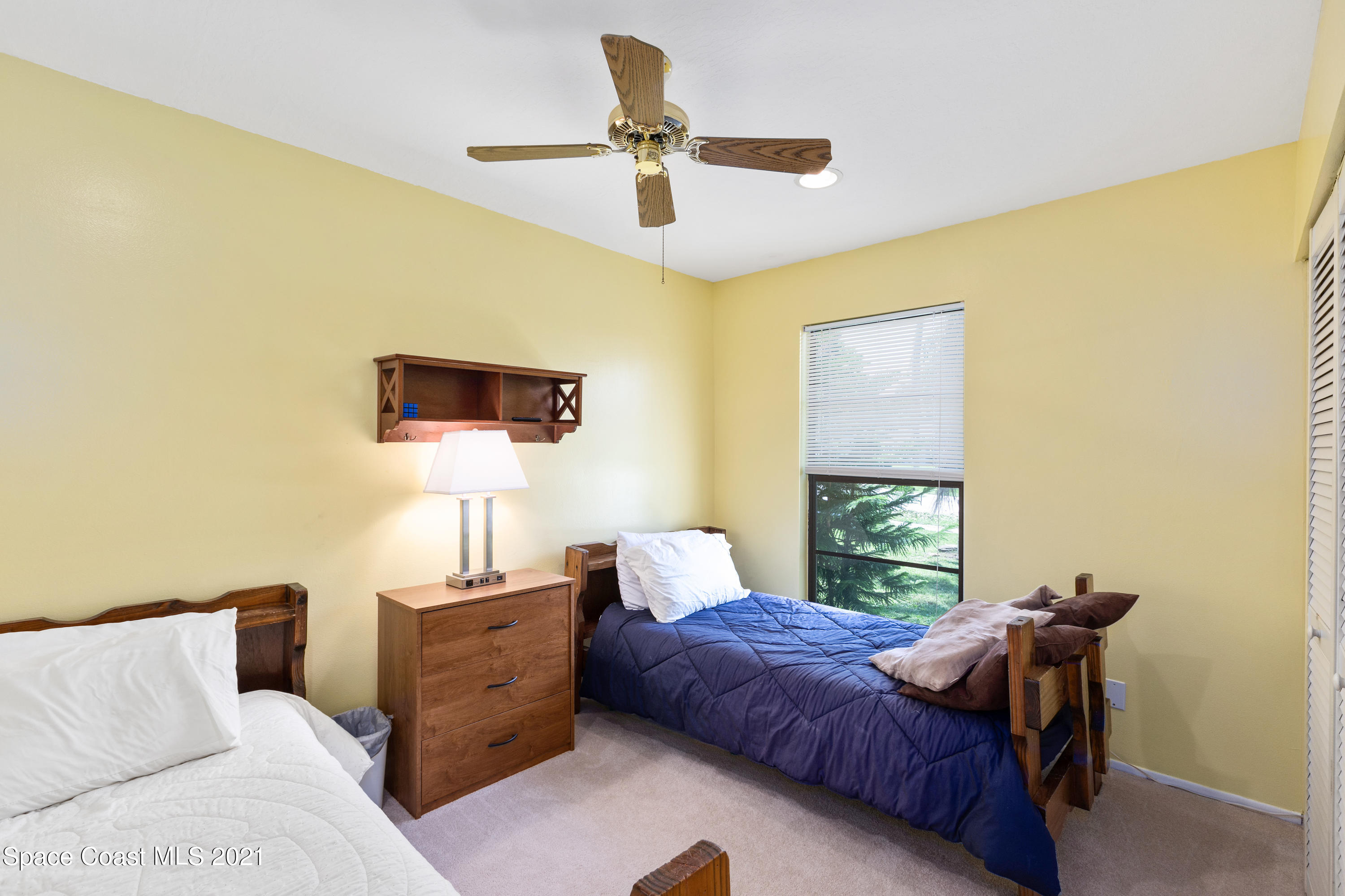 1410 Creel Road Northeast Palm Bay, FL 32905 - Photo 21 of 39 a bedroom with a bed and a window