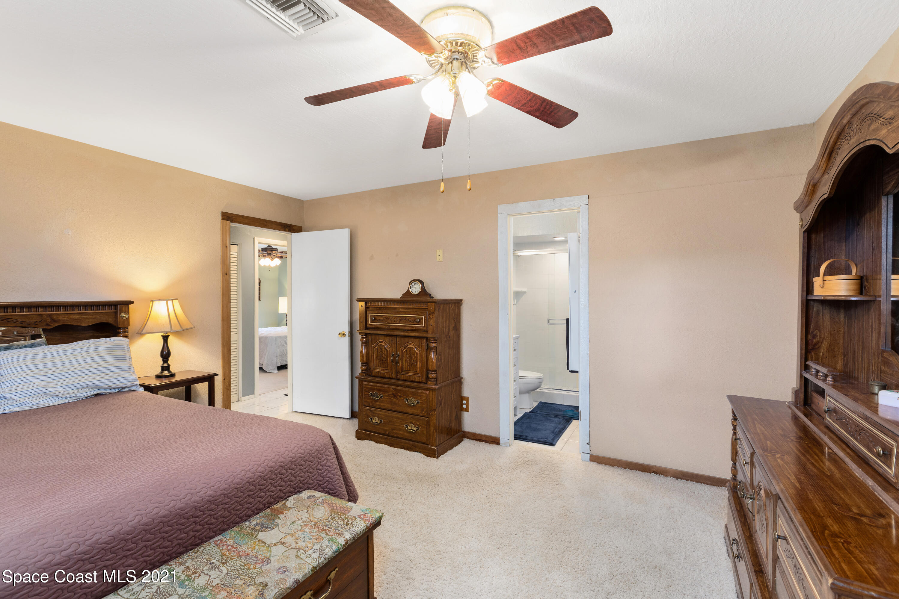 1410 Creel Road Northeast Palm Bay, FL 32905 - Photo 24 of 39 a bedroom with a bed and a television