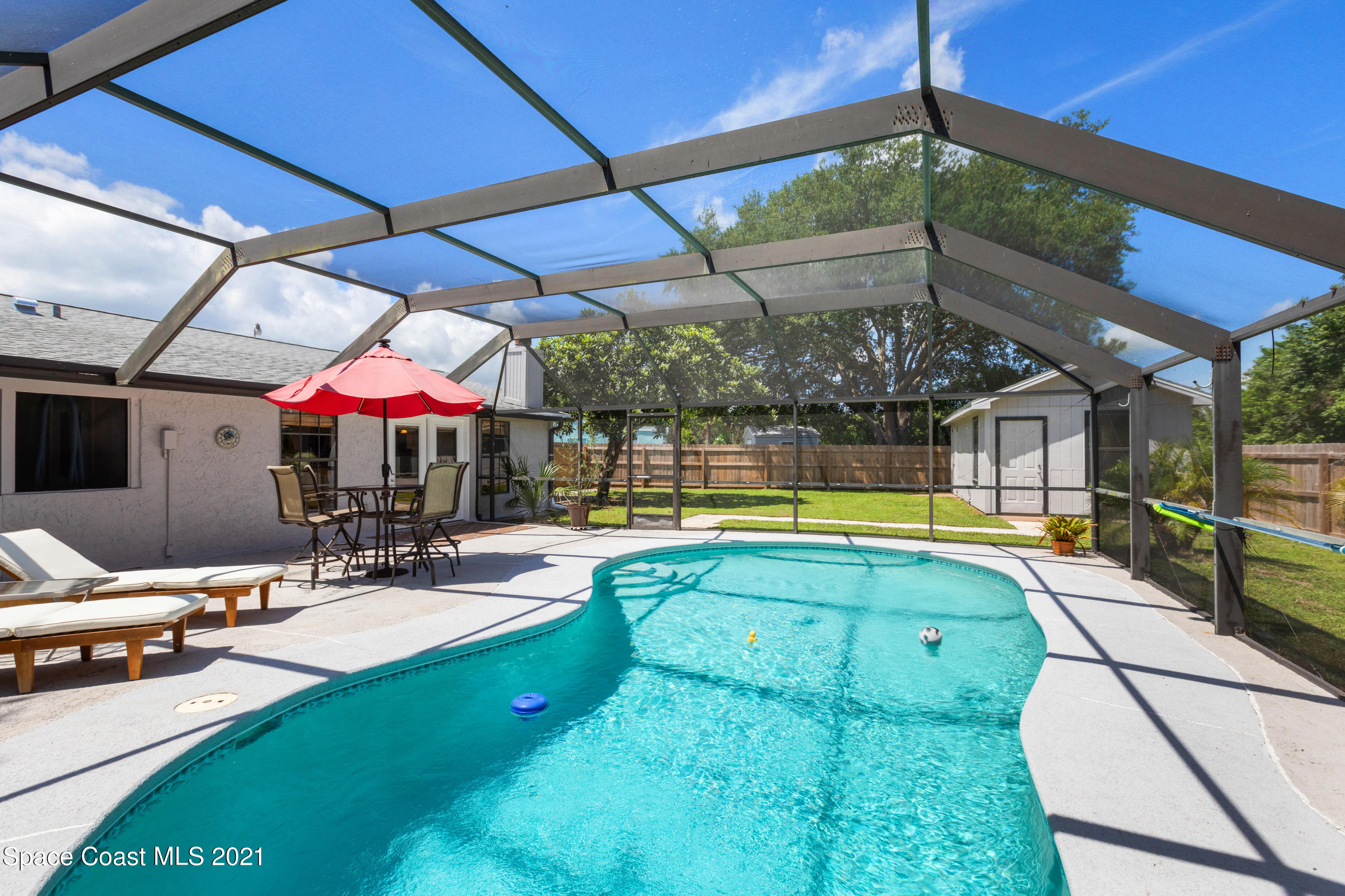 1410 Creel Road Northeast Palm Bay, FL 32905 - Photo 31 of 39 a view of a swimming pool with a patio