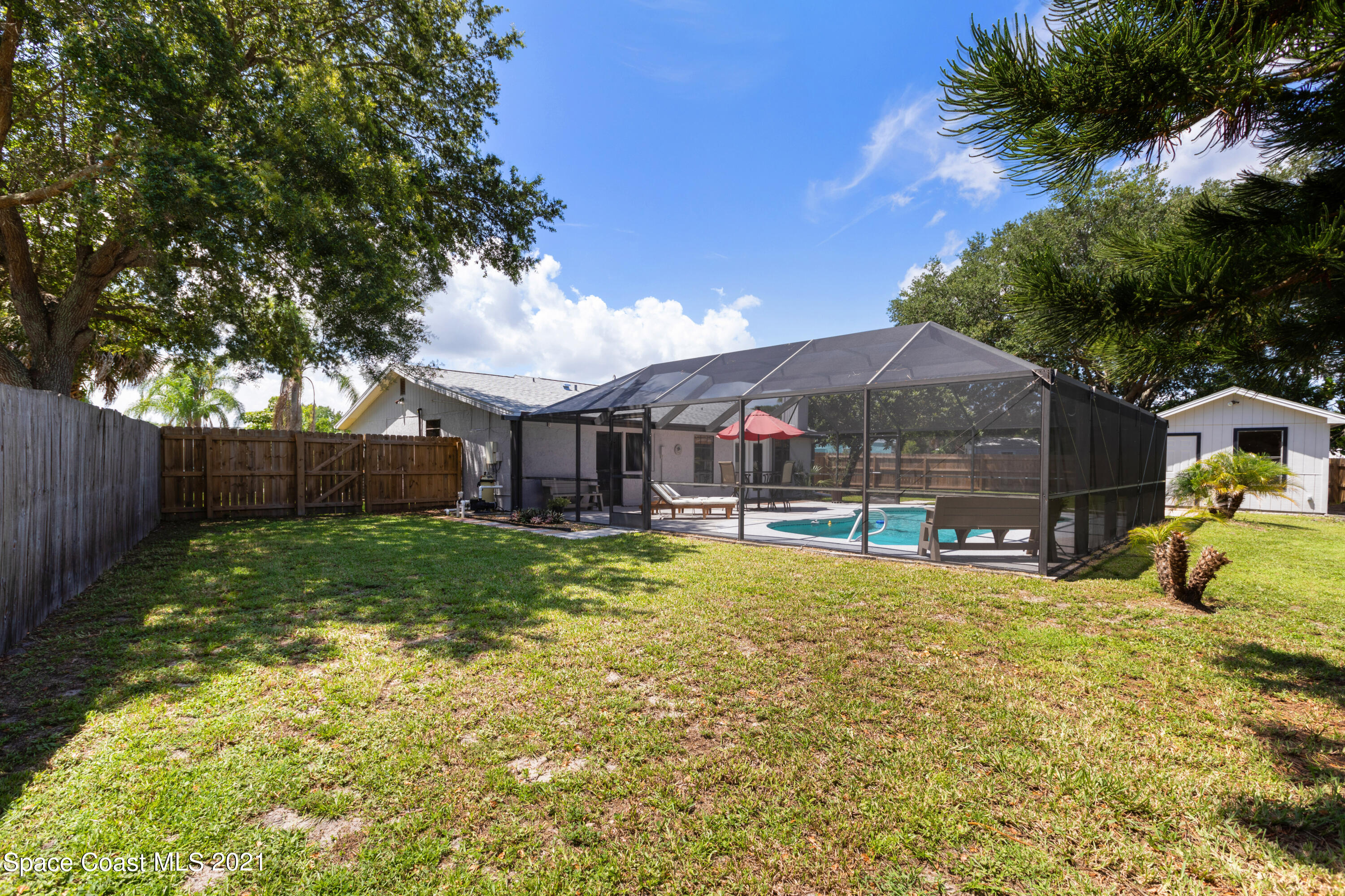 1410 Creel Road Northeast Palm Bay, FL 32905 - Photo 35 of 39 a view of a house with swimming pool and sitting area