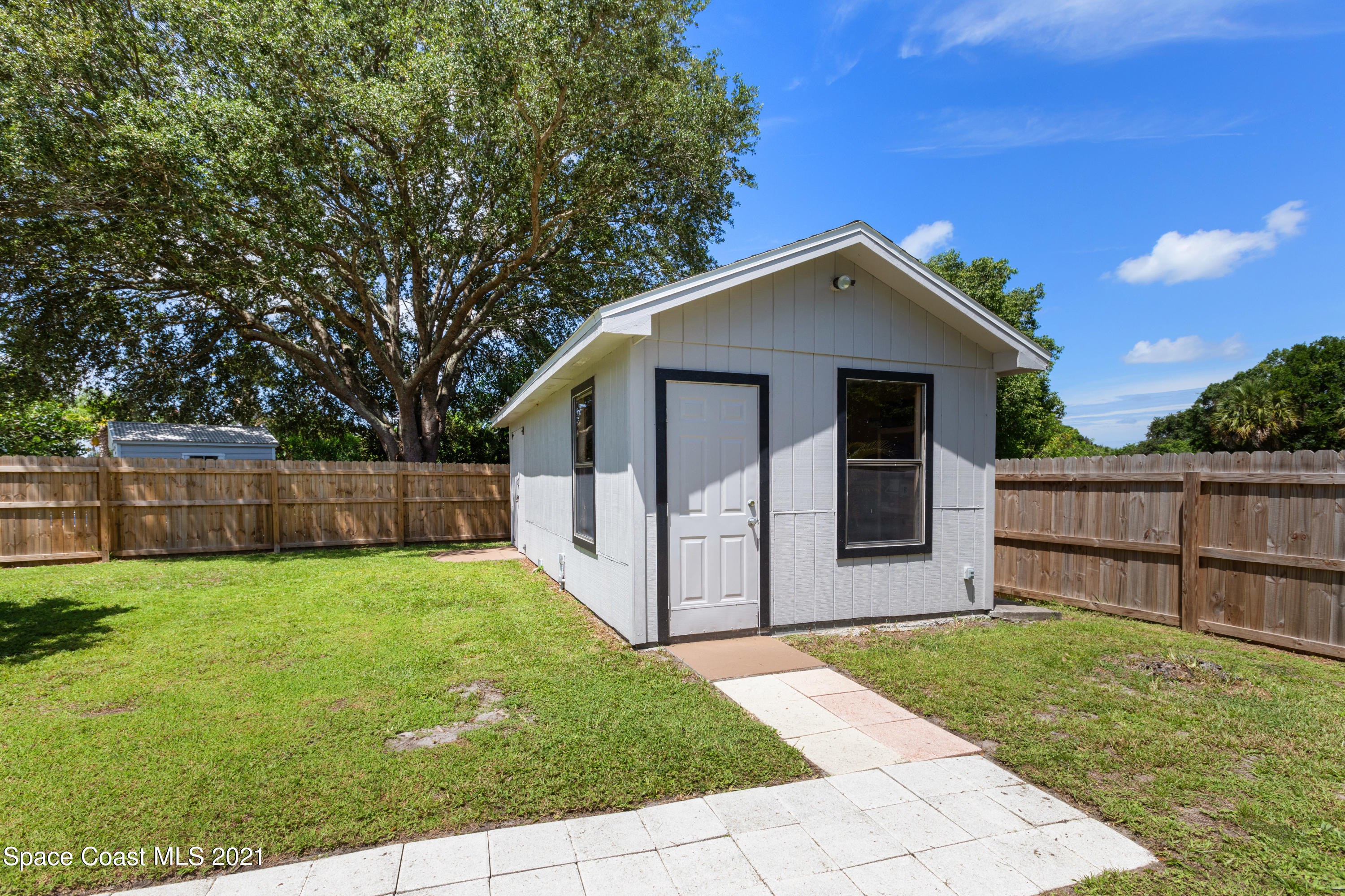 1410 Creel Road Northeast Palm Bay, FL 32905 - Photo 38 of 39 a view of a house with a yard and wooden fence