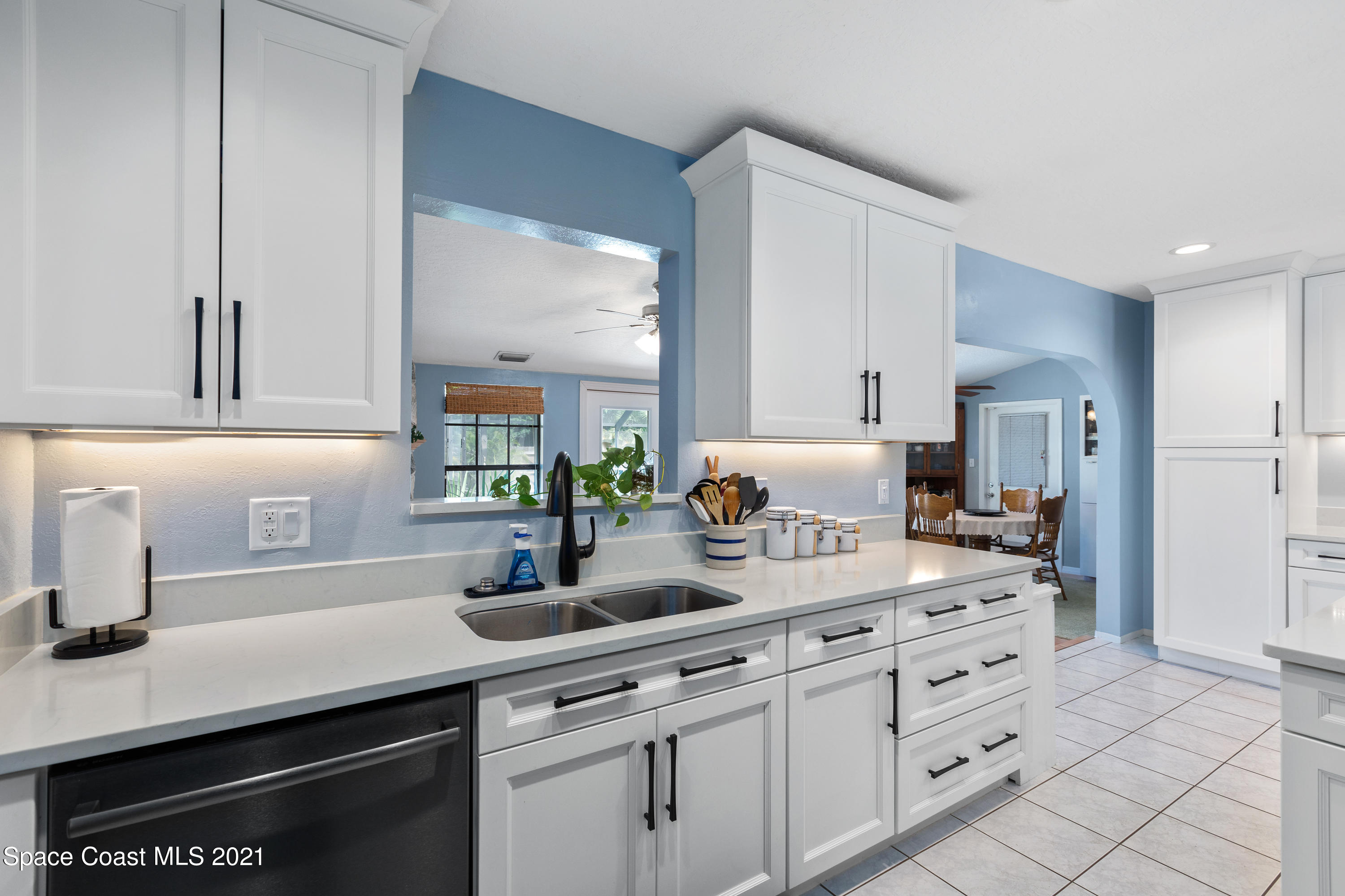 1410 Creel Road Northeast Palm Bay, FL 32905 - Photo 5 of 39 a kitchen with cabinets appliances and a counter top space