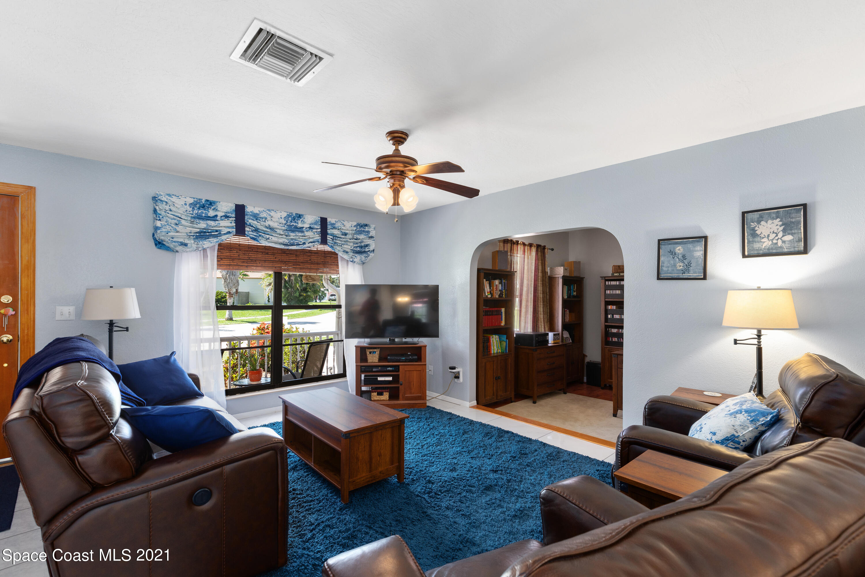 1410 Creel Road Northeast Palm Bay, FL 32905 - Photo 10 of 39 a living room with furniture ceiling fan and a window