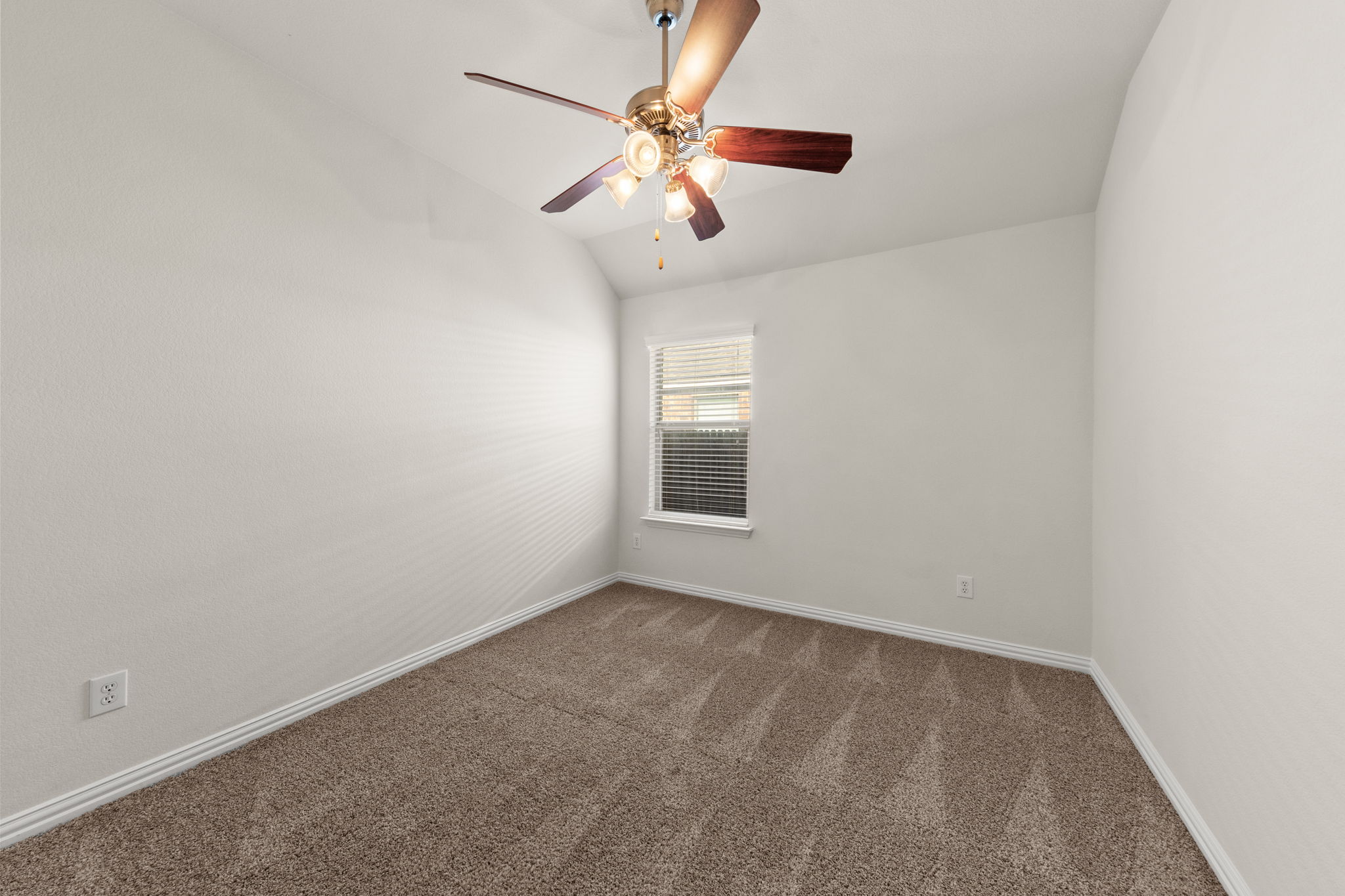 411 Tascate Street Georgetown, TX 78628 - Photo 34 of 41 A well-lit bedroom features plush carpeting and a modern ceiling fan for ultimate comfort.