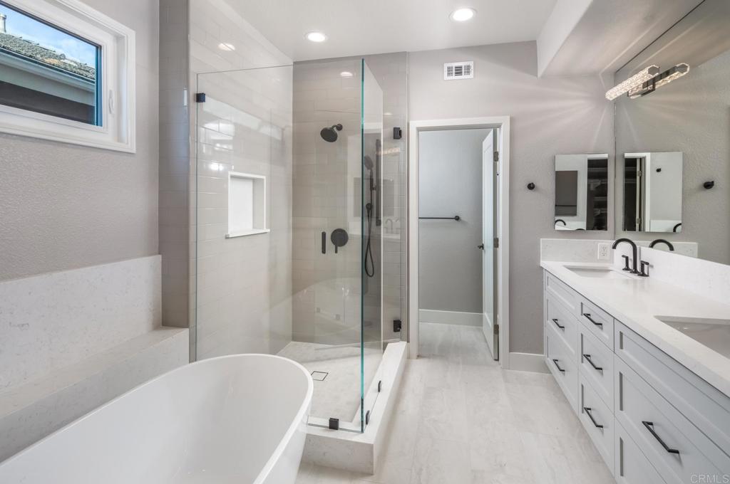 1808 Amalfi Drive Encinitas, CA 92024 - Photo 19 of 33 a spacious bathroom with a granite countertop sink mirror and shower