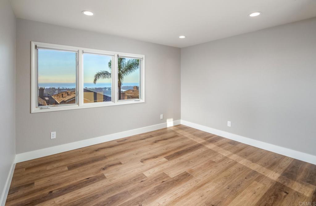1808 Amalfi Drive Encinitas, CA 92024 - Photo 22 of 33 a view of empty room with wooden floor and fan