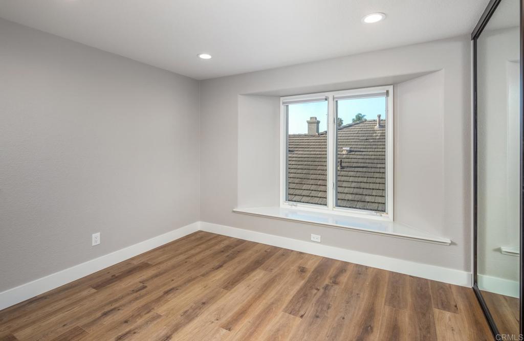 1808 Amalfi Drive Encinitas, CA 92024 - Photo 24 of 33 a view of an empty room with wooden floor and a window