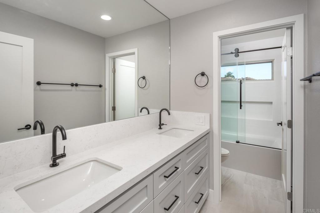 1808 Amalfi Drive Encinitas, CA 92024 - Photo 25 of 33 a bathroom with a sink and a mirror