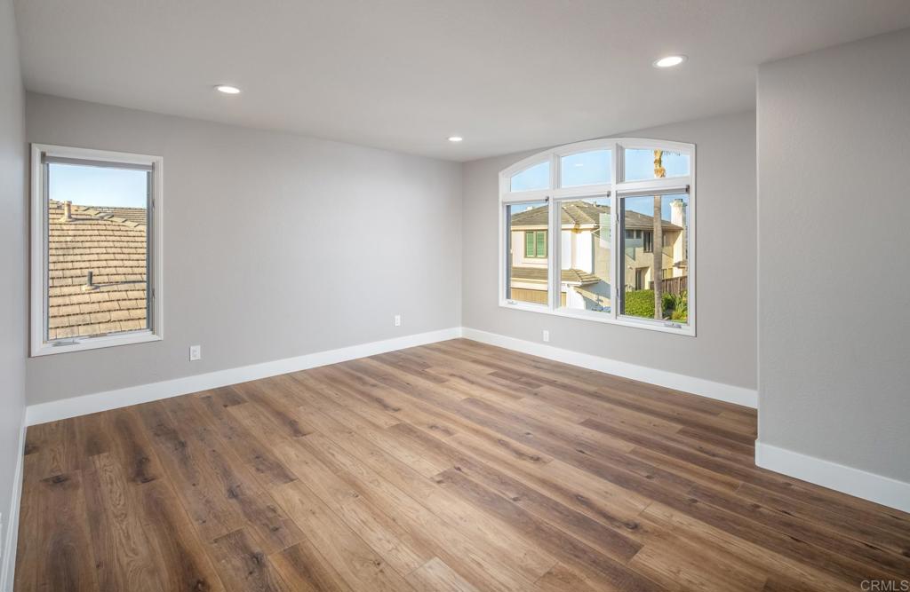 1808 Amalfi Drive Encinitas, CA 92024 - Photo 26 of 33 a view of an empty room with wooden floor and a window