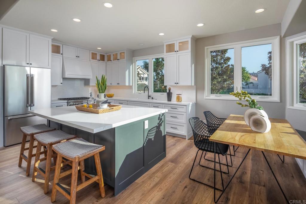 1808 Amalfi Drive Encinitas, CA 92024 - Photo 7 of 33 a kitchen with a table chairs and a refrigerator