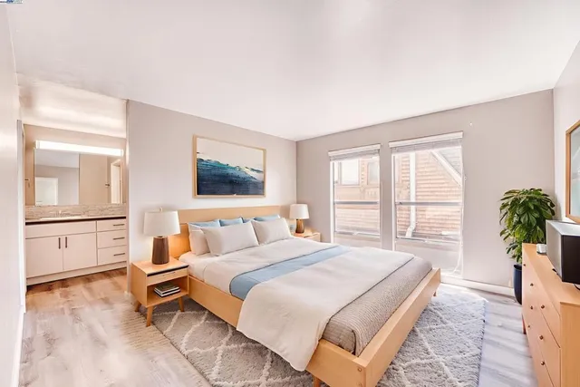 a spacious bedroom with a large bed and a window