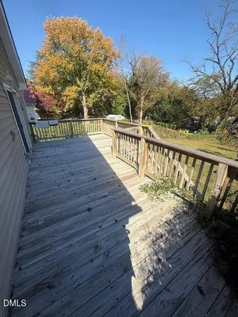 a view of balcony with wooden floor and fence