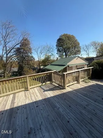 a view of balcony with wooden floor and fence