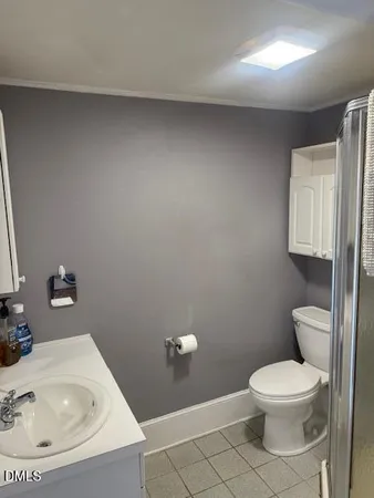 a white toilet sitting next to a bathroom sink