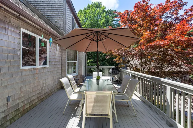 a view of balcony with furniture and umbrella