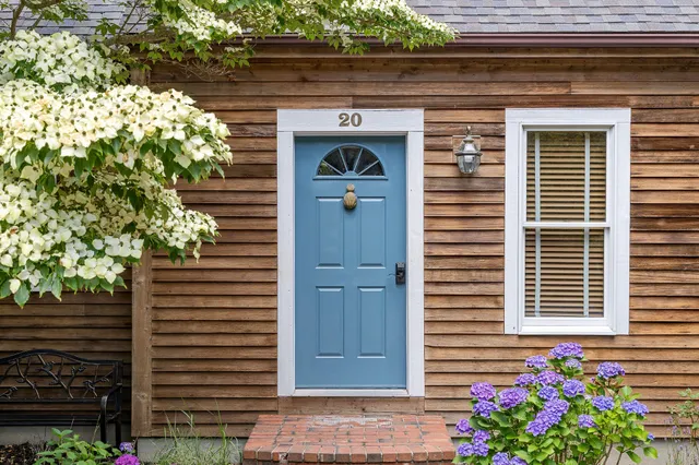 a front view of a house with plants