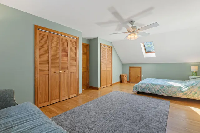 a bedroom with a bed dresser and a window