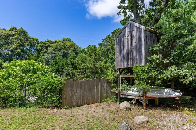 a backyard of a house with outdoor seating