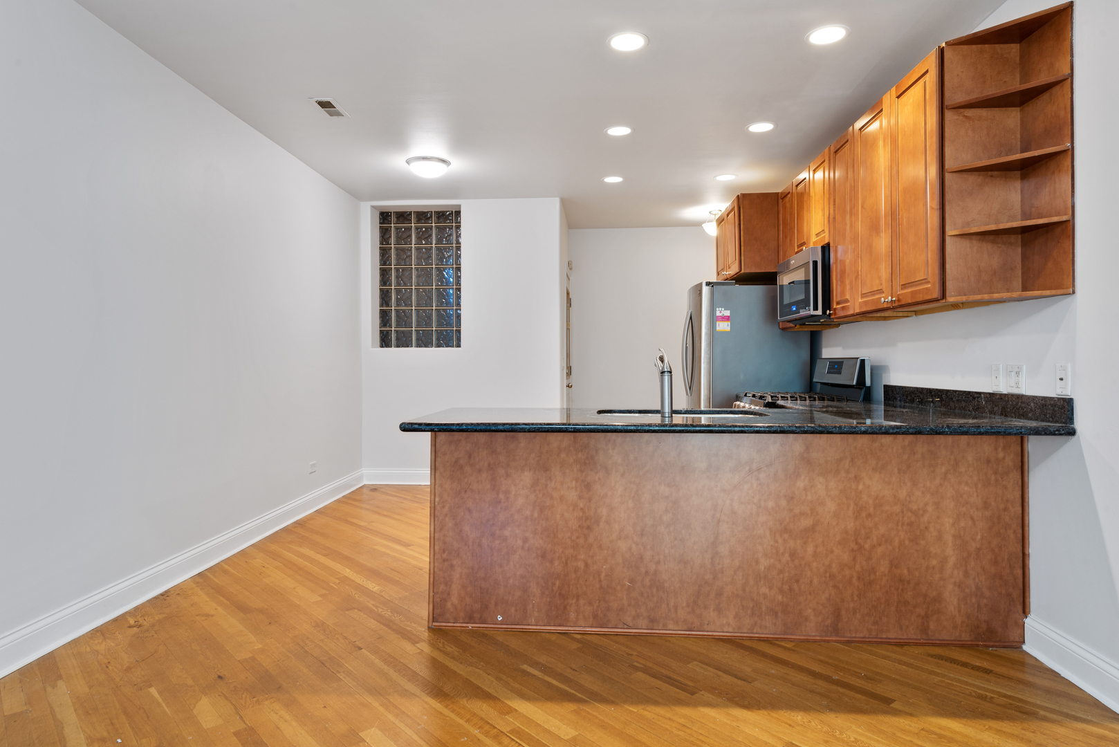 7010 South Clyde Avenue, Unit 3N Chicago, IL 60649 - Photo 2 of 19 a view of kitchen with stainless steel appliances granite countertop a refrigerator and a stove top oven