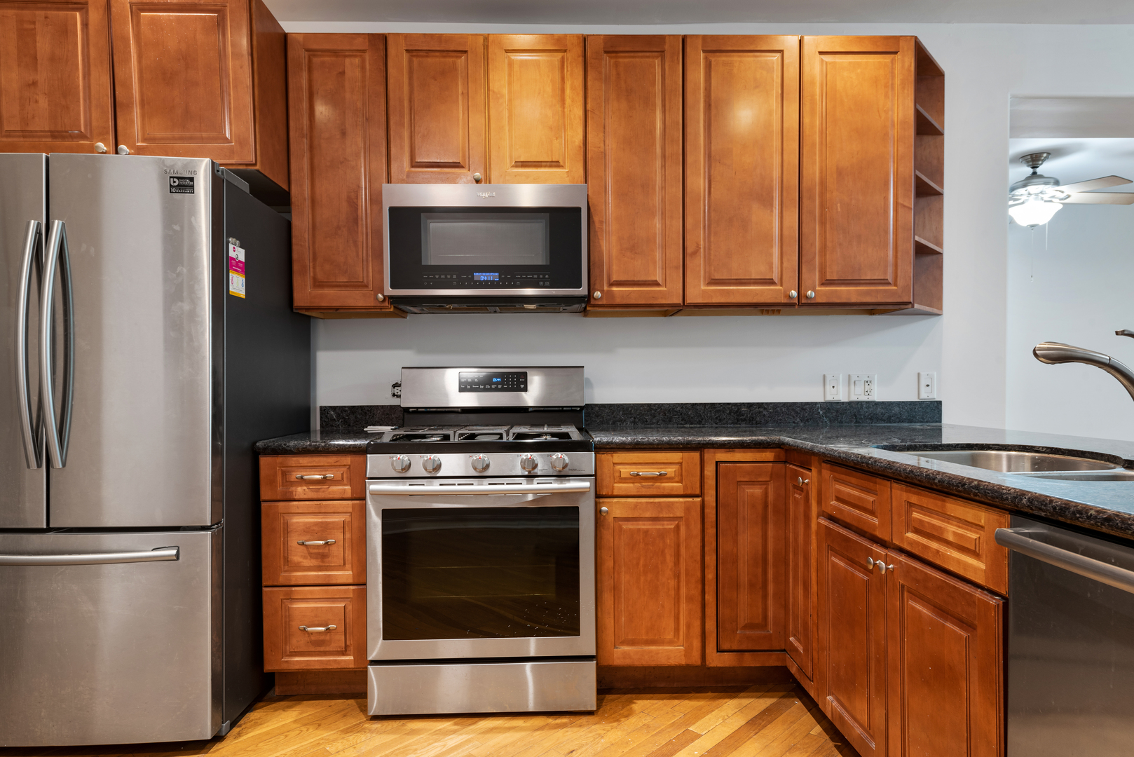 7010 South Clyde Avenue, Unit 3N Chicago, IL 60649 - Photo 3 of 19 a kitchen with stainless steel appliances granite countertop a refrigerator stove and microwave