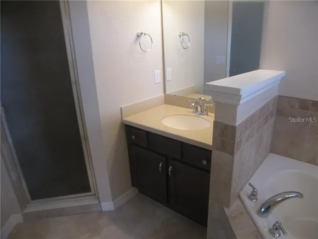 a bathroom with a sink and mirror