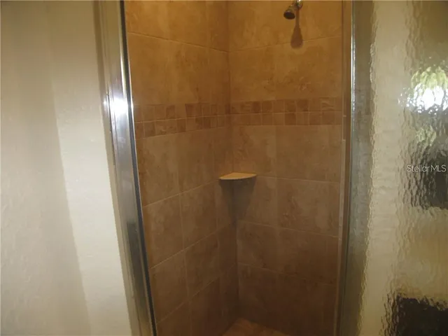 a bathroom with a glass door shower
