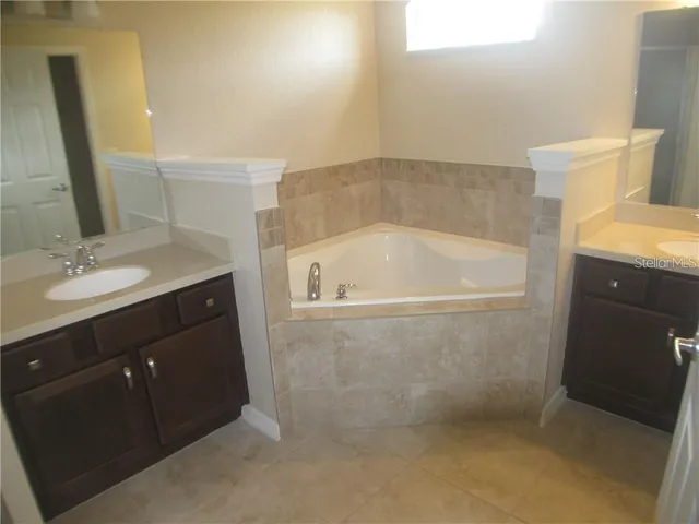 a bathroom with a granite countertop sink a toilet and mirror