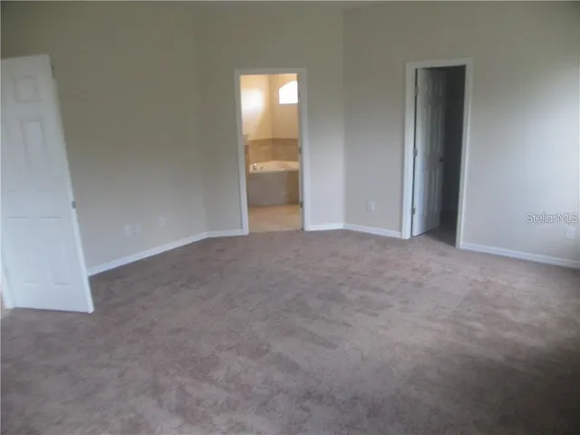 a view of an empty room and a window