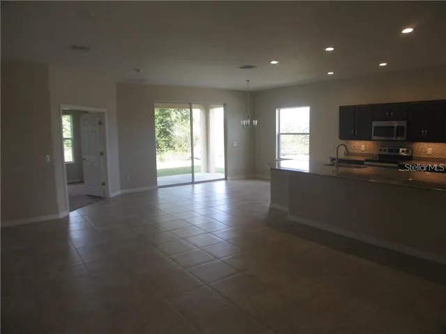 a view of a kitchen with a sink and a window